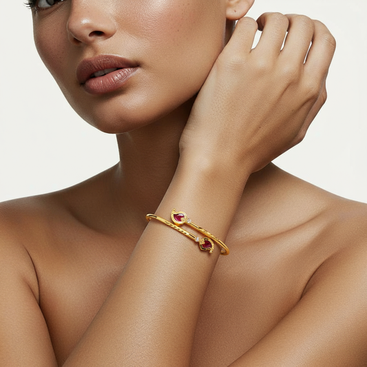 A woman wearing a Me19 micro gold-plated mango cuff bangle with red stones. A traditional yet modern piece of artificial jewellery from Kerala, India
